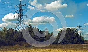 High-voltage power lines at storm clouds