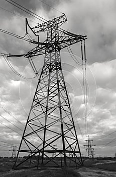 High-voltage  power lines at storm clouds