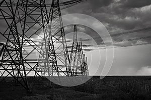 High-voltage  power lines at storm clouds