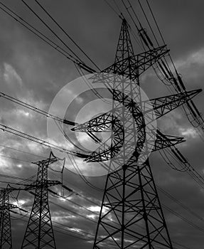 High-voltage  power lines at storm clouds