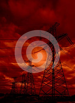 High-voltage  power lines at storm clouds