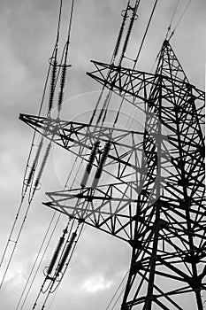 High-voltage  power lines at storm clouds