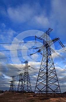 High-voltage  power lines at storm clouds