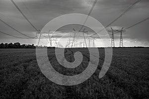 High-voltage  power lines at storm clouds