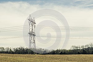 High Voltage Power Lines Stretching Across a Field