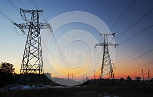 High-voltage power lines during sunrise