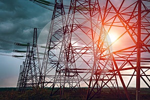 High-voltage power lines at sunset.