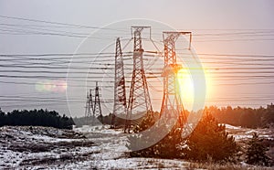 High-voltage power lines at sunset