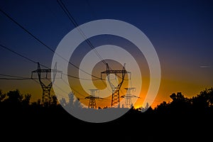 high-voltage power lines at sunset. electricity distribution sta