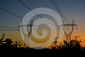 high-voltage power lines at sunset. electricity distribution sta