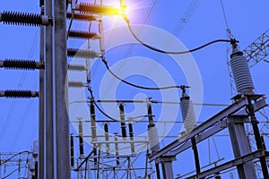 High-voltage power lines at sunset. electricity distribution station