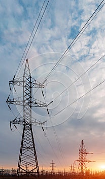 High-voltage power lines at sunset. electricity distribution station. high voltage electric transmission tower.