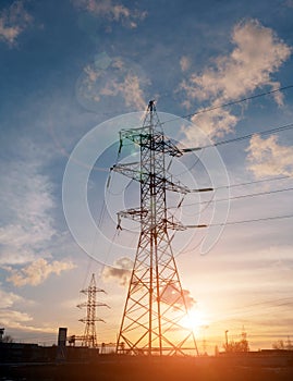 High-voltage power lines at sunset. electricity distribution station. high voltage electric transmission tower.