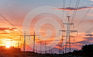 High-voltage power lines at sunset. electricity distribution station. high voltage electric transmission tower.