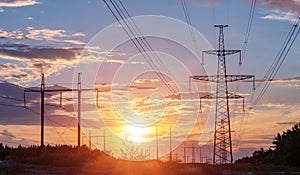 High-voltage power lines at sunset. electricity distribution station. high voltage electric transmission tower.