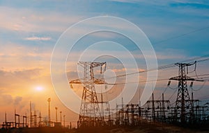 High-voltage power lines at sunset. electricity distribution station. high voltage electric transmission tower.