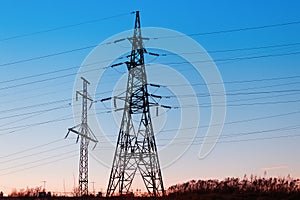 High-voltage power lines at sunset. Electricity distribution station