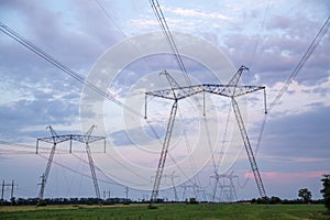 High-voltage power lines at sunset. High voltage electric transmission tower