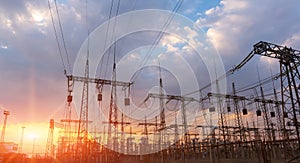 High-voltage power lines at sunset or sunrise. High voltage electric transmission tower