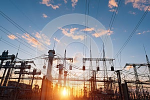 High-voltage power lines at sunset or sunrise. High voltage electric transmission tower