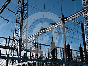 high-voltage power lines of transformer substation against the blue sky