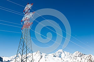 High voltage power lines in winter mountain landscape