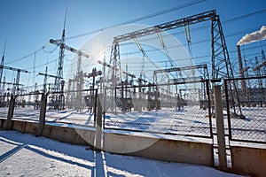 High voltage power lines in the winter. Thermal power plant. High-voltage transformer substation.