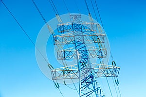 High voltage power pylon against nice blue sky. Energy concept