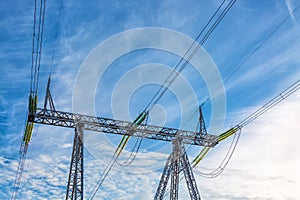 High voltage power pylon on nice blue sky with clouds