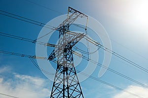 A high voltage power pylons against blue sky