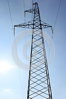 High voltage power pylons against blue sky