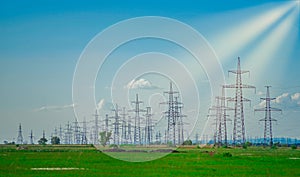High voltage power tower in a green field