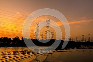 High voltage power tower and nature landscape at sunset