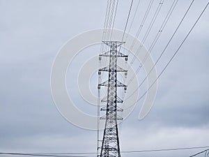 High Voltage Power Tower, Transmission Line, Blue Sky Background.