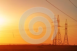 High-voltage power transmission line. Energy pillars. At sunset, dawn. high-tension