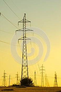 High-voltage power transmission line. Energy pillars. At sunset, dawn. high-tension