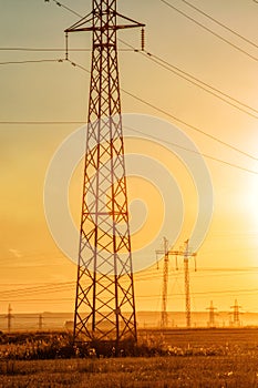 High-voltage power transmission line. Energy pillars. At sunset, dawn. high-tension