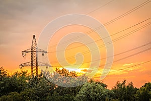 High voltage power transmission tower with electrical energy wires photo