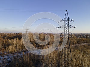 High-voltage power transmission towers over farm fields