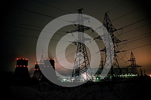 High-voltage power transmission towers in sunset sky