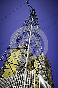 High Voltage Pylon In Front Of Houses, Urban Scene