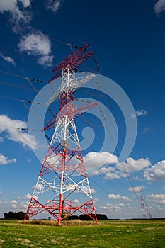 High voltage pylons against blue sky