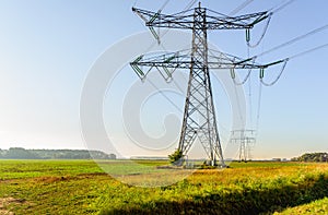 High voltage pylons and cables in a rural area