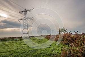 High-voltage pylons in a Dutch polder landscape in autumn