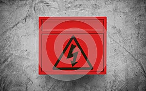 High voltage sign symbol, on red electronic box on concrete wall texture background