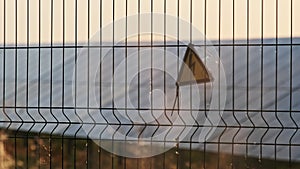 High Voltage Sign on a Wire Fence of the Solar Plant