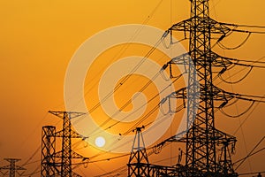 high voltage steel transmission tower during sunset
