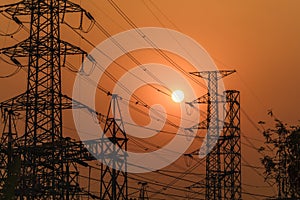 high voltage steel transmission tower during sunset