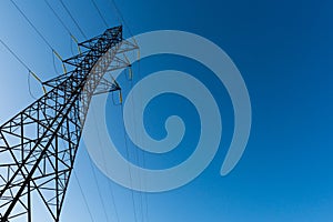 High voltage tower with blue sky background