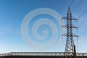 High voltage tower with blue sky background